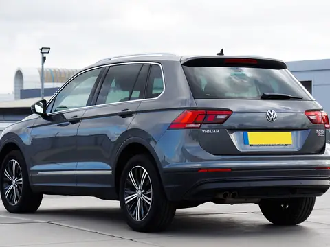 Rear window of a grey SUV in a lot